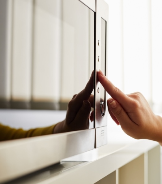 Person pressing a button on a microwave, showing how Utilita's Power Price List helps customers see appliance running costs.